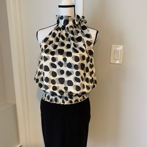 Sleeveless silk like blouse ties at the neck